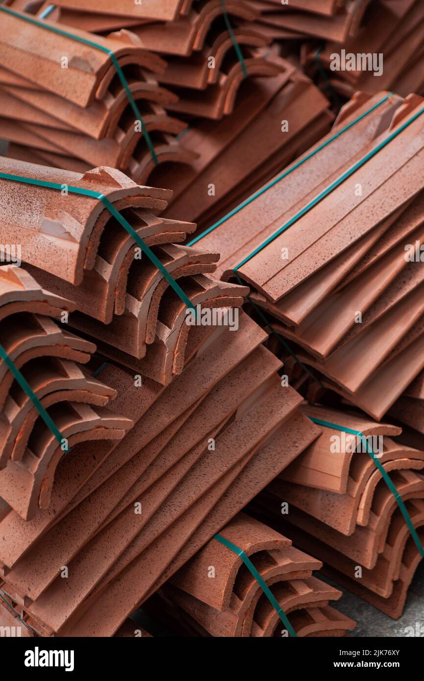 Bundles of earthen tiles on a building site Stock Photo