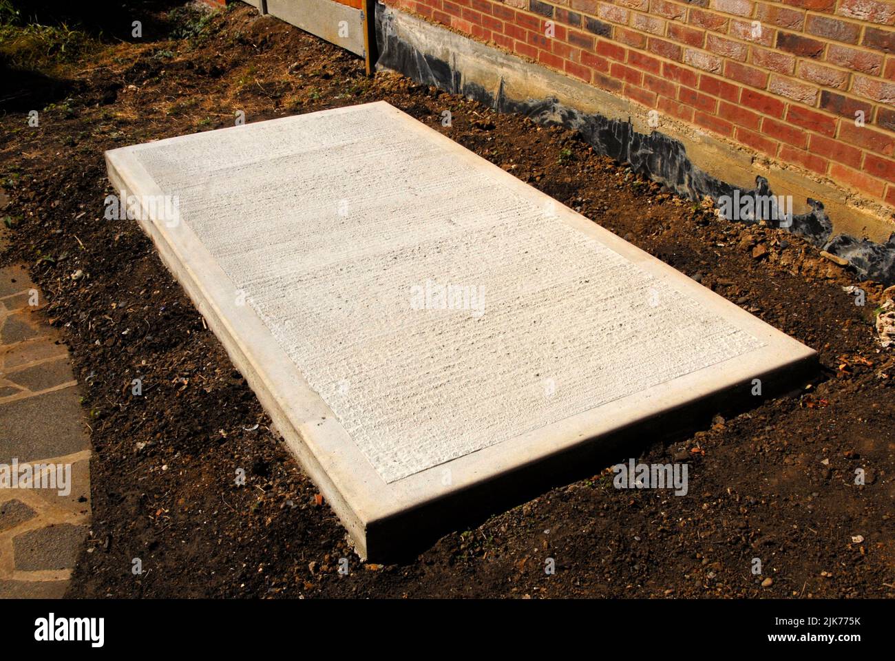 Concrete base for new shed after shuttering removed showing ridged centre and smooth border Stock Photo
