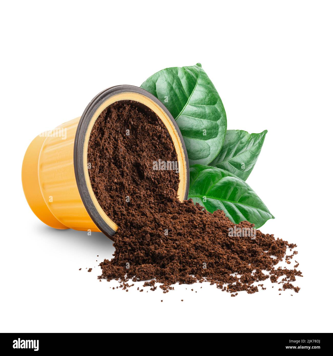 Coffee scattered from capsule with green leaves isolated Stock Photo