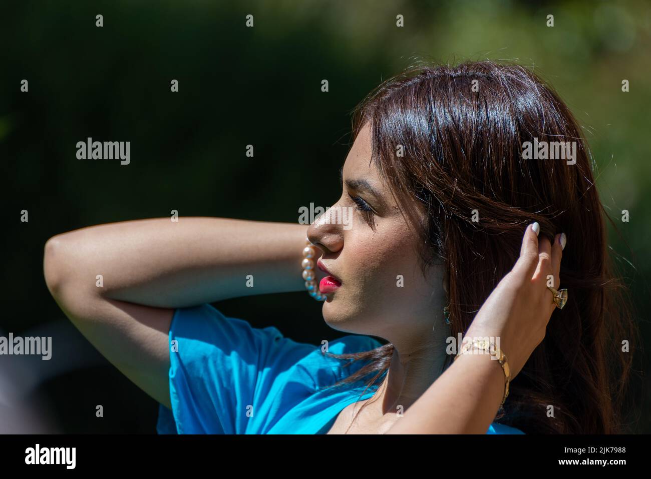 Blue dress, beautiful person looking to the right Stock Photo