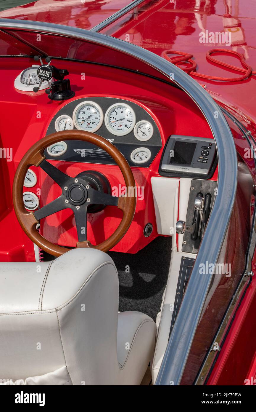 steering wheel and control panel in the cockpit of a fast speedboat