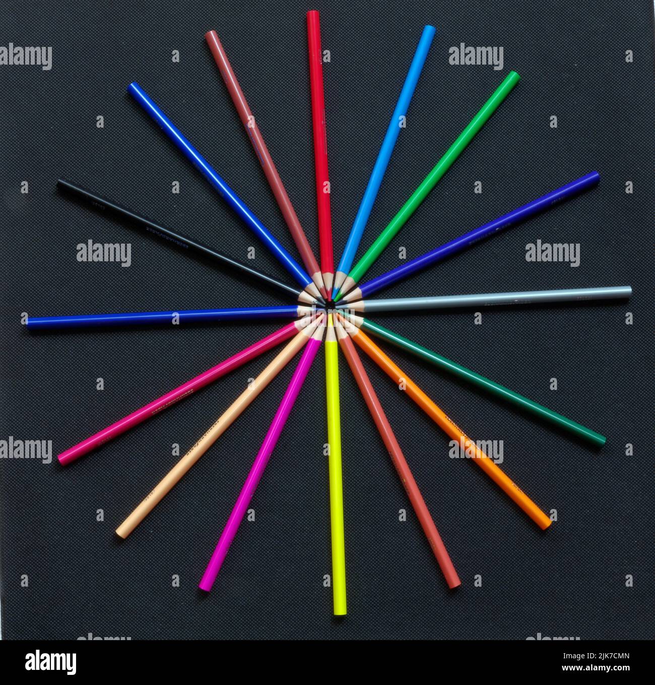 Painting and drawing: Various colored pencils on black background, arranged in a circle Stock Photo