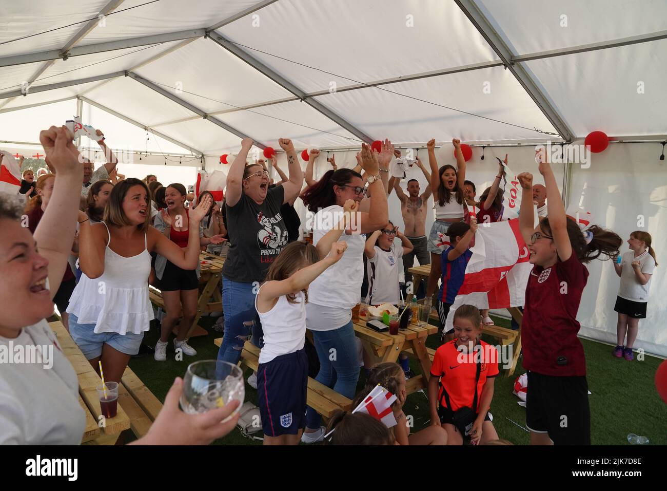 Fans celebrate the second England goal in Aylesbury United WFC, the former club of Lionesses forward Ellen White, in Bierton, Aylesbury, watch a screening of the UEFA Women's Euro 2022 final held at Wembley Stadium, London. Picture date: Sunday July 31, 2022. Stock Photo
