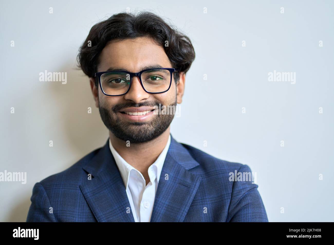 Happy young indian business man wearing suit and glasses. Headshot portrait Stock Photo