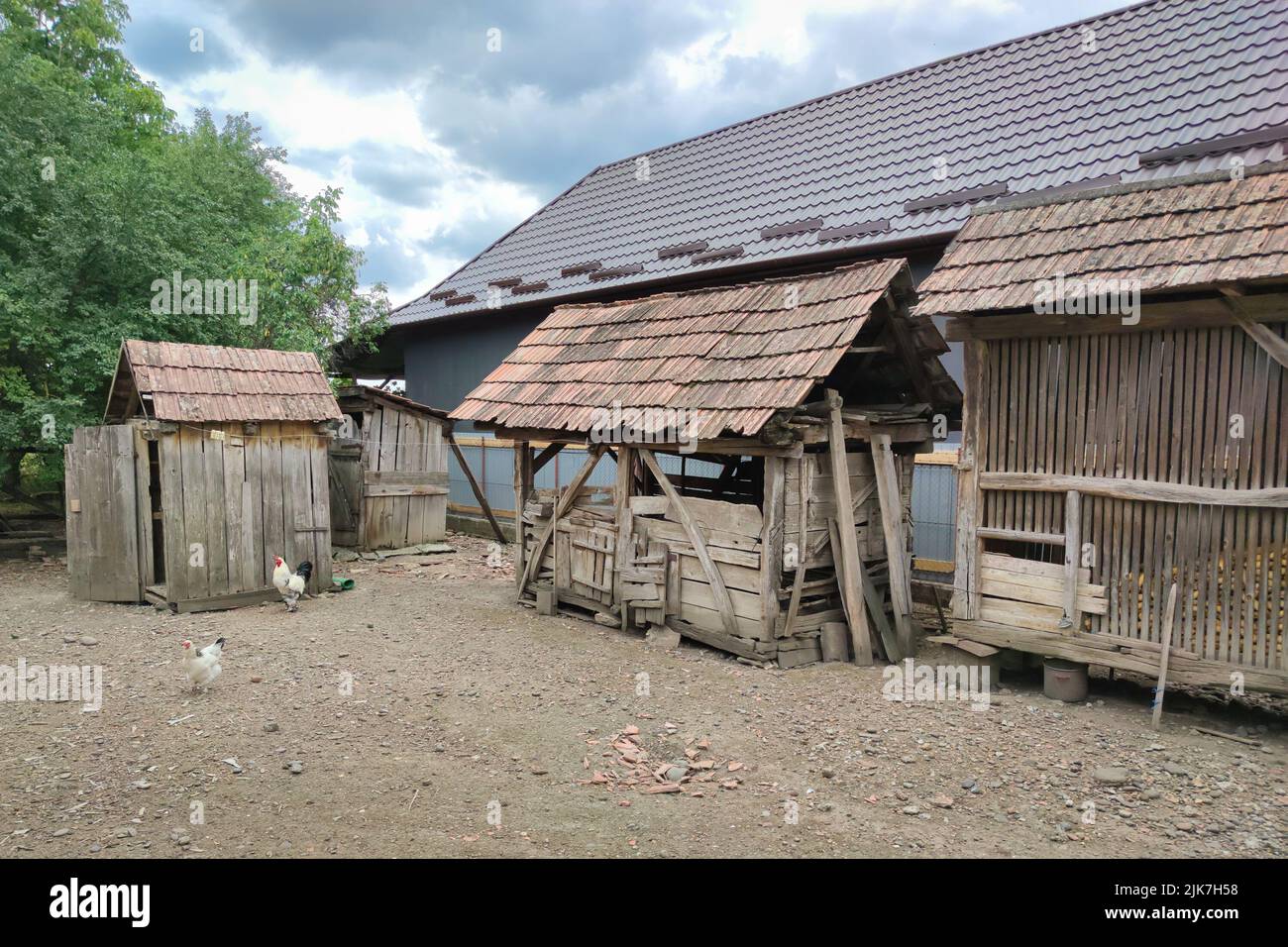 Old wooden sheds in a yard where corn for the chickens is kept Stock Photo