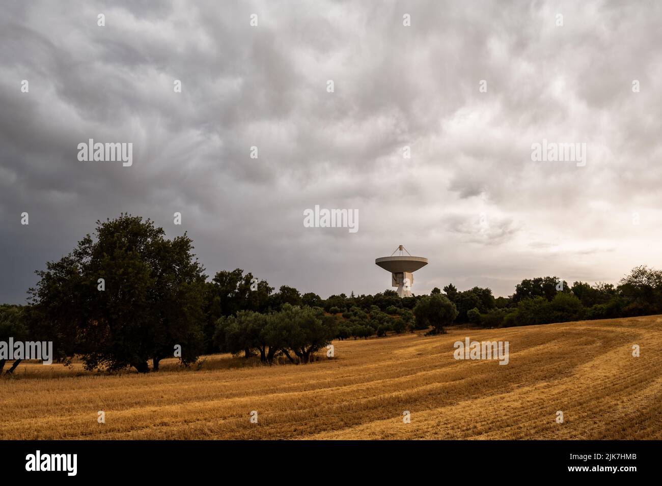 Guadalajara, Spain. 30th July, 2022. View of a radio telescope from the Yebes Observatory during a summer storm. Yebes Observatory is the main scientific and technical facility of the National Geographic Institute of Spain. The facilities include two radio telescopes, a solar tower, an astrograph and a gravimeter. Credit: Marcos del Mazo/Alamy Live News Stock Photo
