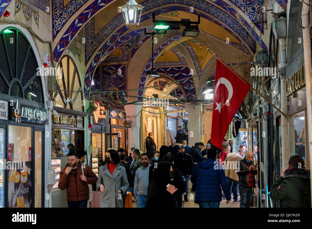 Istanbul, Turkey - 2022: People shopping in the Grand Bazar, handmade lamps, bags and carpets for sale Stock Photo