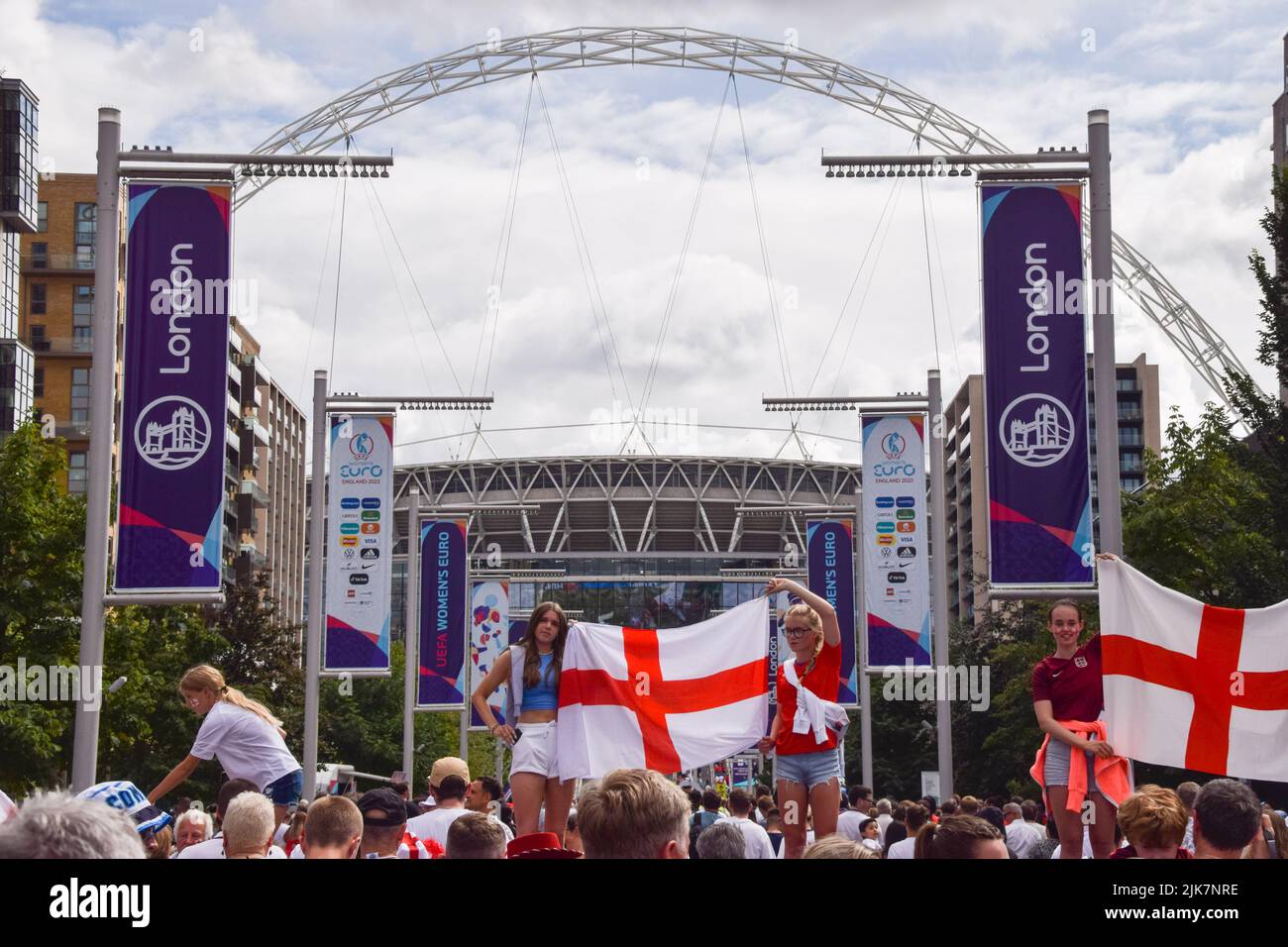 London, UK. 31st July, 2022. Fans hold an England flag outside Wembley Stadium ahead of the UEFA Women's Euro football final match, with England playing against Germany. Credit: SOPA Images Limited/Alamy Live News Stock Photo
