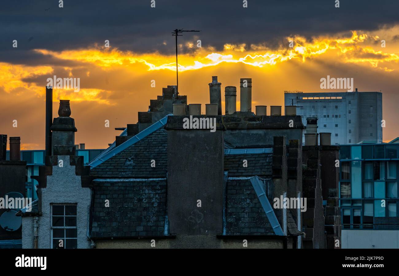 Leith, Edinburgh, Scotland, United Kingdom, 31st July 2022. UK Weather: Summer sunset over Leith: the sun sets over the rooftops of Leith with Chancelot flour mill n the distance Stock Photo