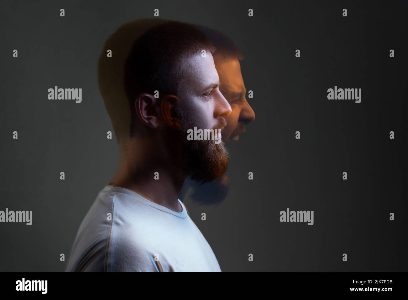 Side view portrait of two-faced man in calm serious and angry screaming expression. Different emotion inside and outside mood. Internally suffering, dissociative identity disorder. Double exposure. Stock Photo