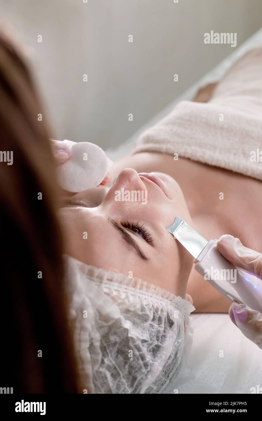 Cosmetologist, beautician making facial treatment with ultrasonic