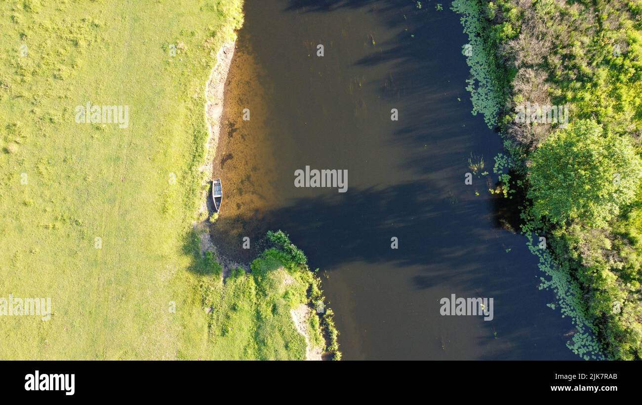 boat near the river bank shooting with a drone Stock Photo - Alamy