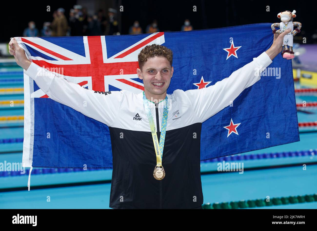 Birmingham, UK. 31st July 2022; Sandwell Aquatics Centre, Birmingham, Midlands, England: Day 3 of the 2022 Commonwealth Games: Lewis Clareburt (NZL) with his Gold Medal and national flag after winning the Men's 200m Butterfly Final Credit: Action Plus Sports Images/Alamy Live News Stock Photo