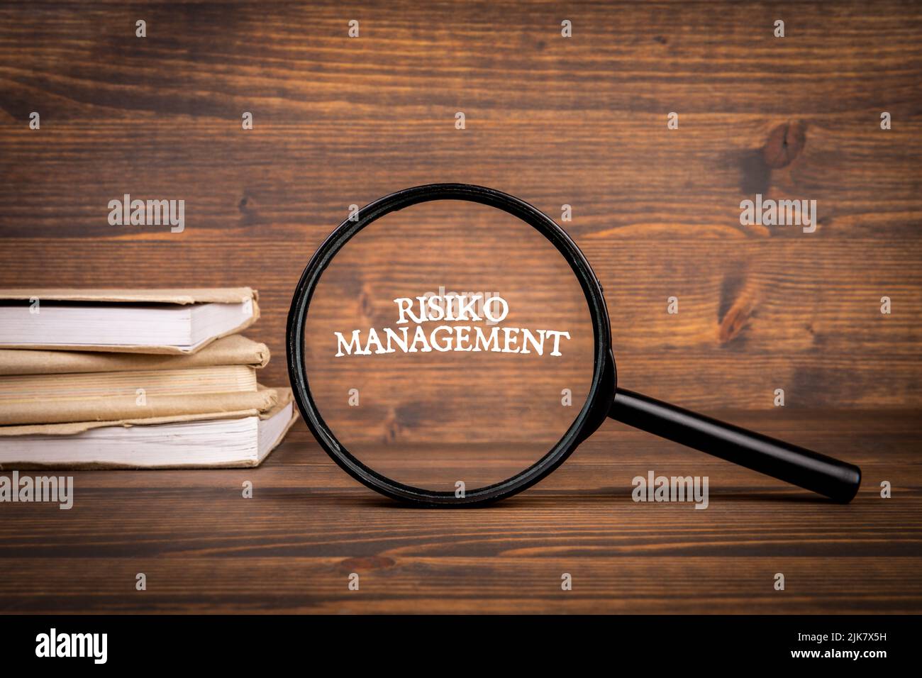 German word Risiko Management, risk management. Magnifying glass with text. Stock Photo