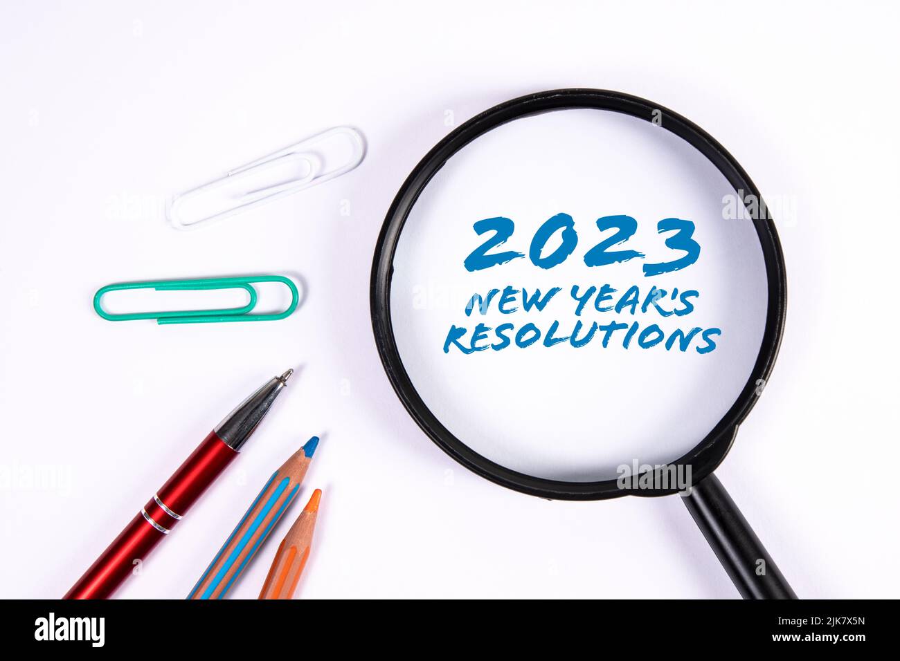 2023 New Year's Resolutions. Magnifying glass on a white background. Stock Photo
