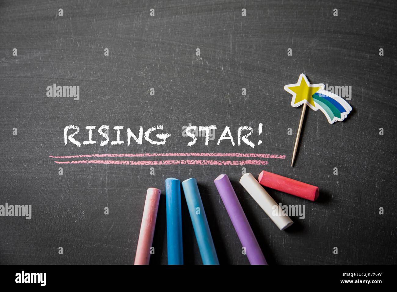 Rising Star. Text and colored pieces of chalk on a blackboard. Stock Photo