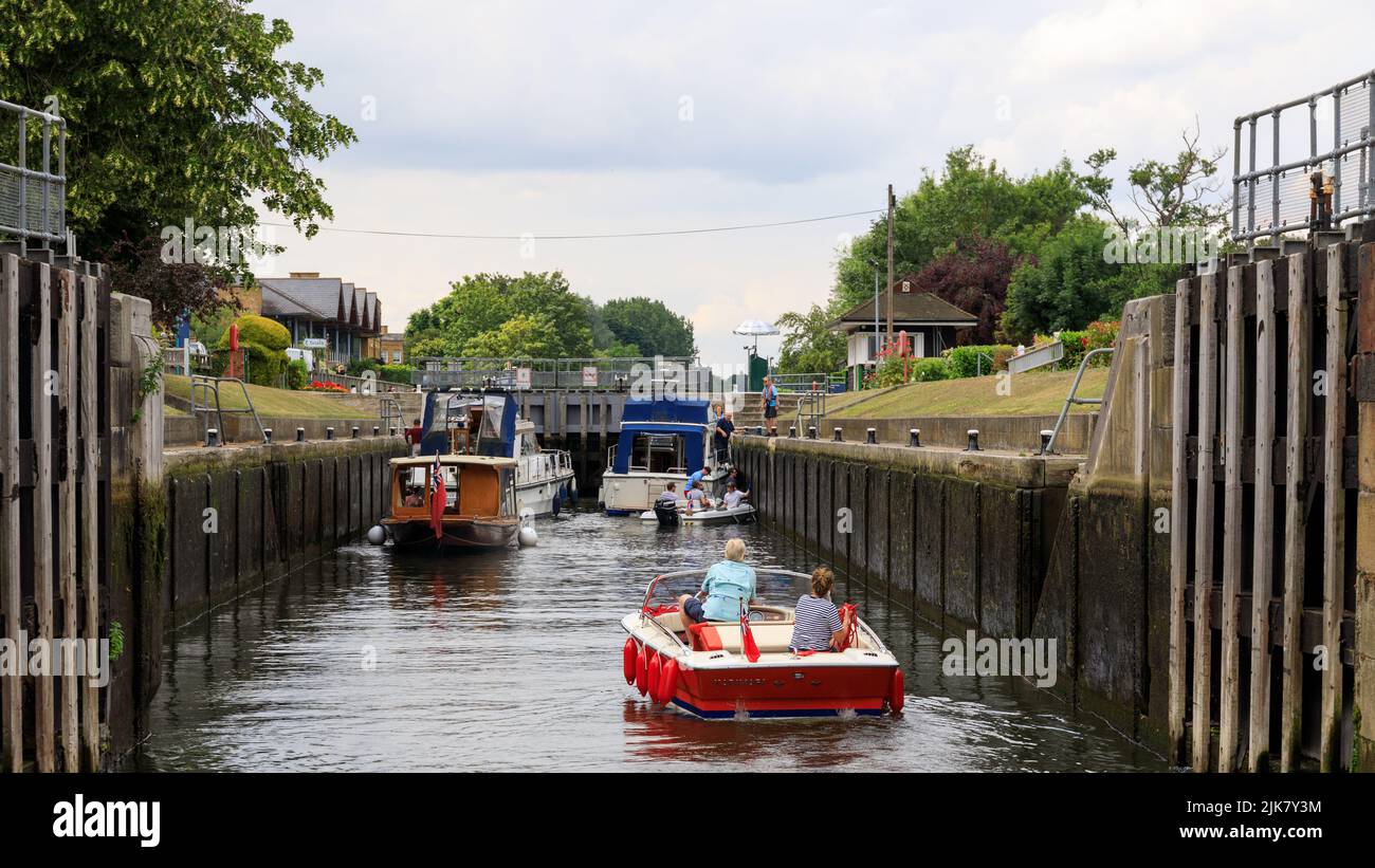 Molesey Lock on the River Thames near Hampton Court with boats entering the lock chamber through the open lock gates Stock Photo