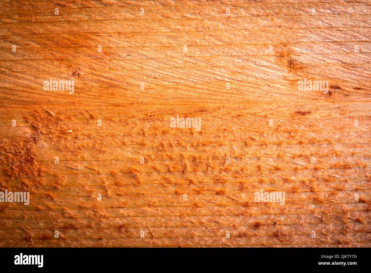 Orange painted wooden board with texture. Scabs and branches. Stock Photo