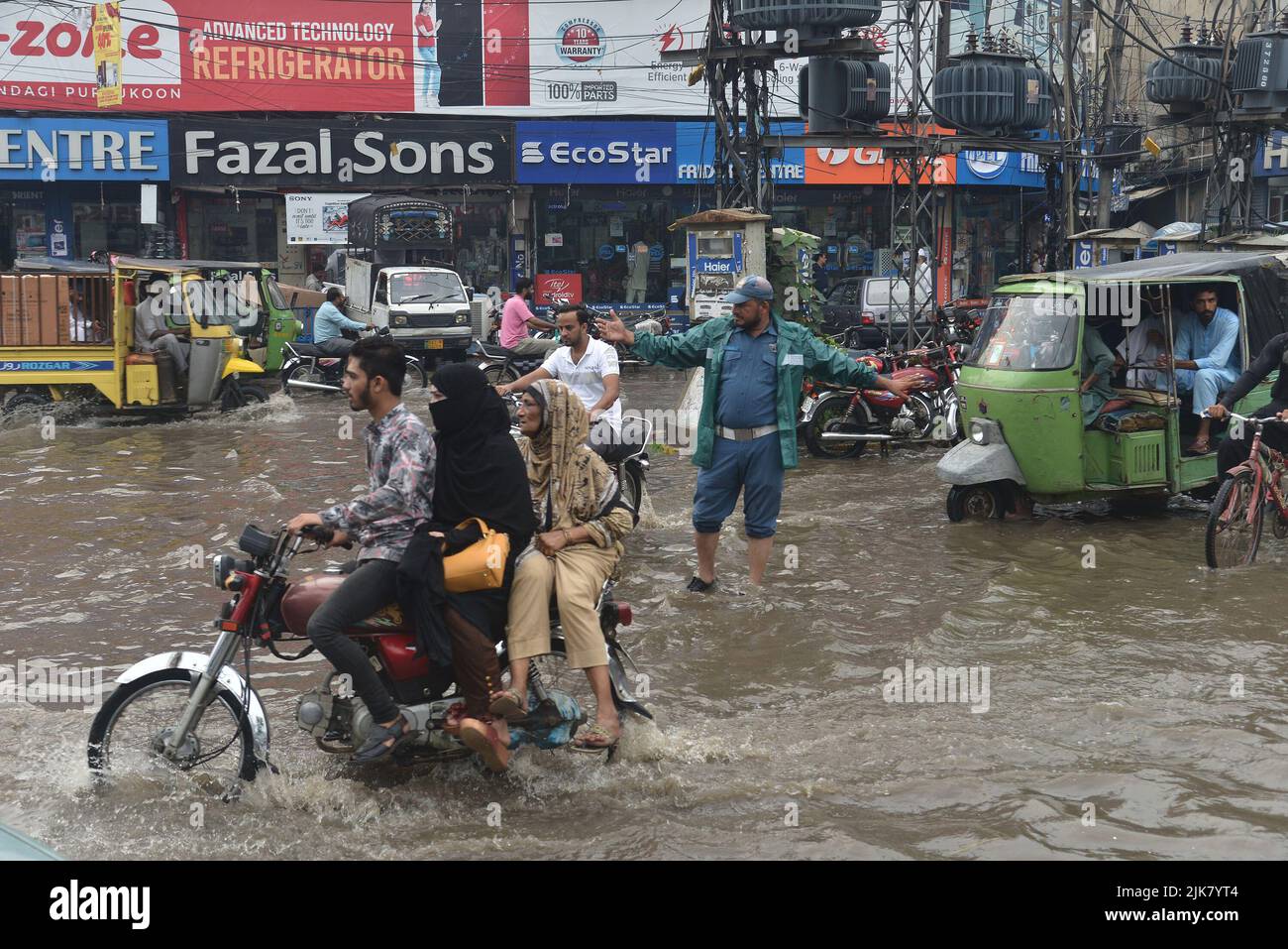 Lahore, Pakistan. 29th July, 2022. Pakistani People Wade Through A 