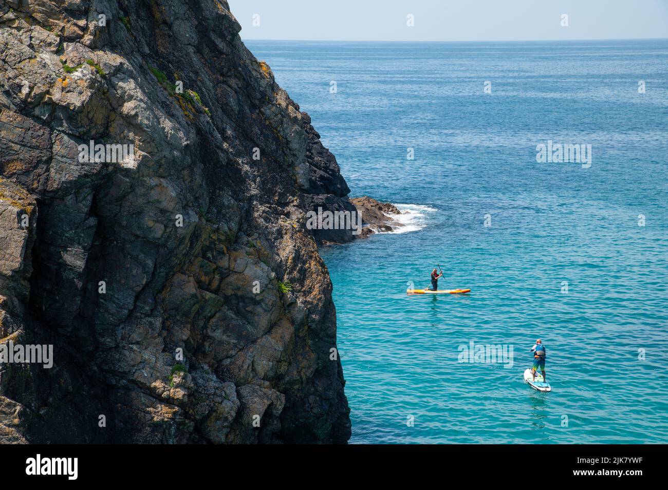 Two bodyboarders at Kynance Cove, Cornwall, UK Stock Photo