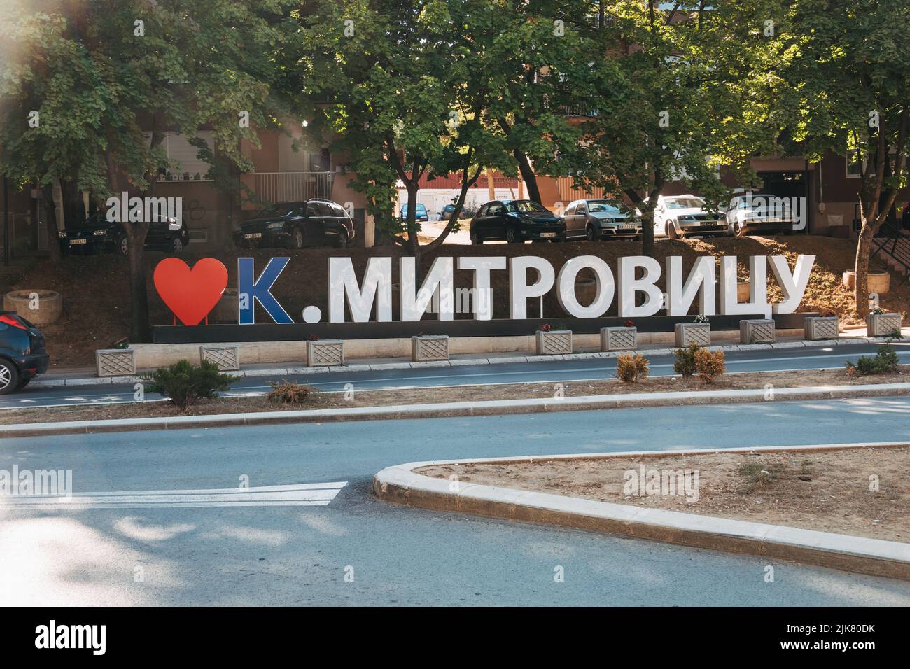 a sign reads "♡ Kosovska Mitrovica" in Serbian Cyrillic in Mitrovica, a