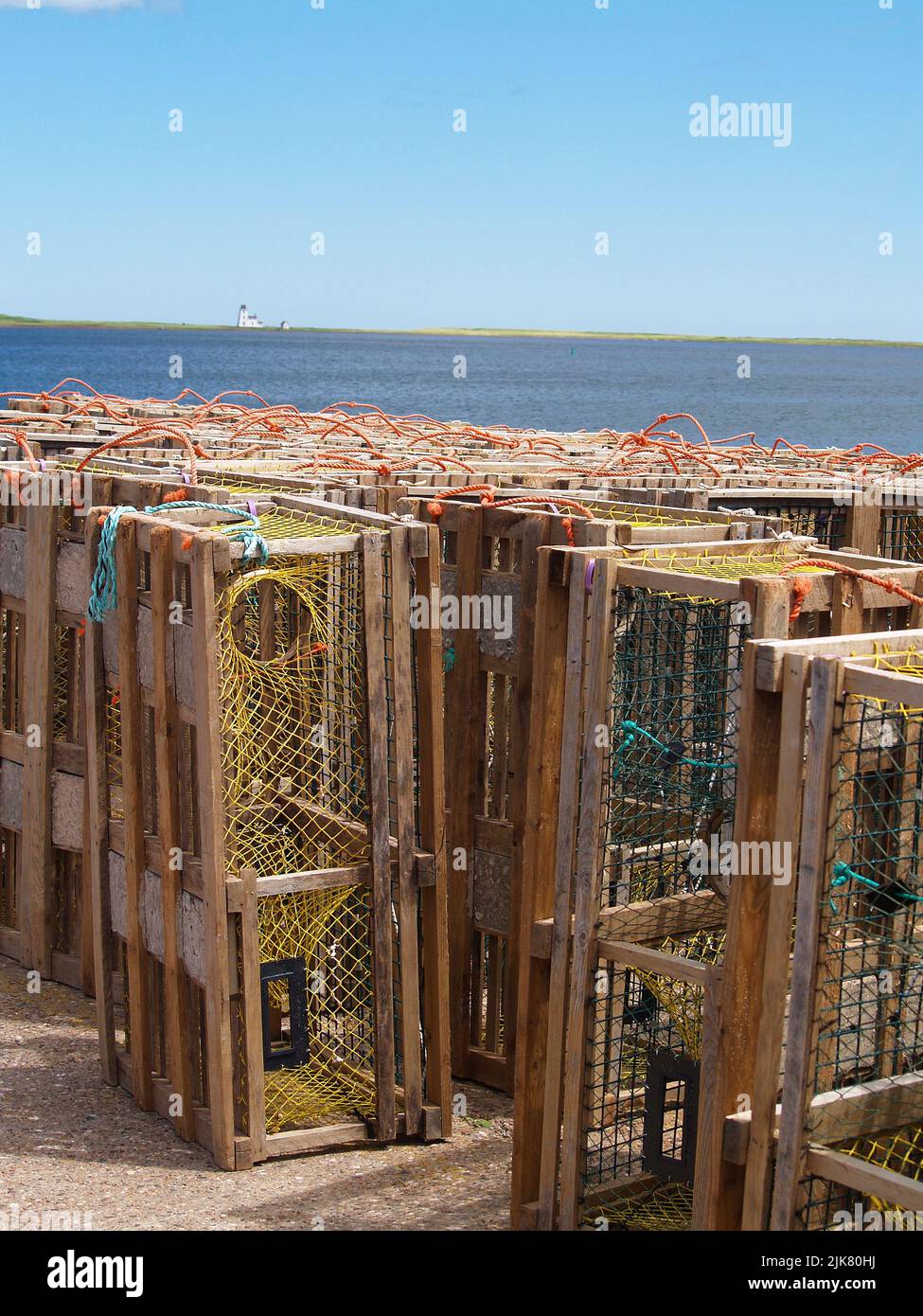 Lobster traps and distance lighthouse, PEI Stock Photo Alamy