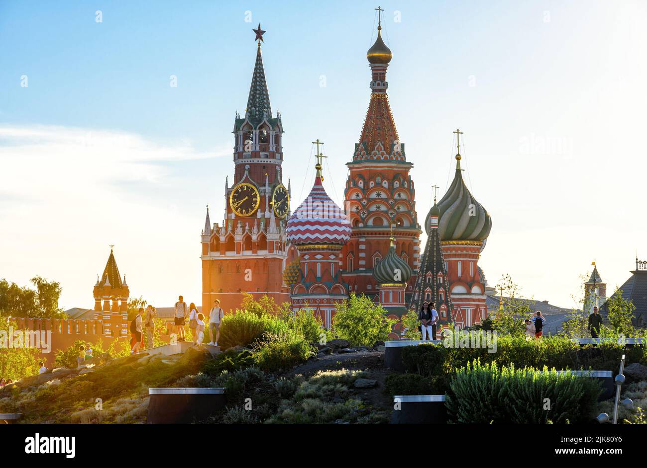 Moscow - Jun 28, 2022: Moscow Kremlin and St Basil's Cathedral view from Zaryadye Park, Russia. People walk near famous tourist attraction of Moscow. Stock Photo