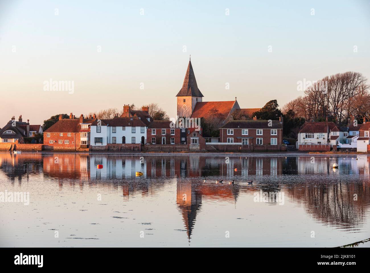 A late winter afternoon view across the harbour to Bosham village, West Sussex, UK Stock Photo