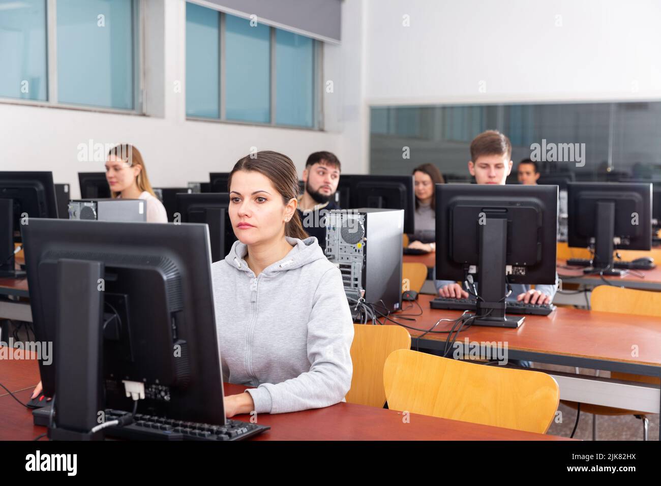 Computer lessons for adults in classroom Stock Photo - Alamy