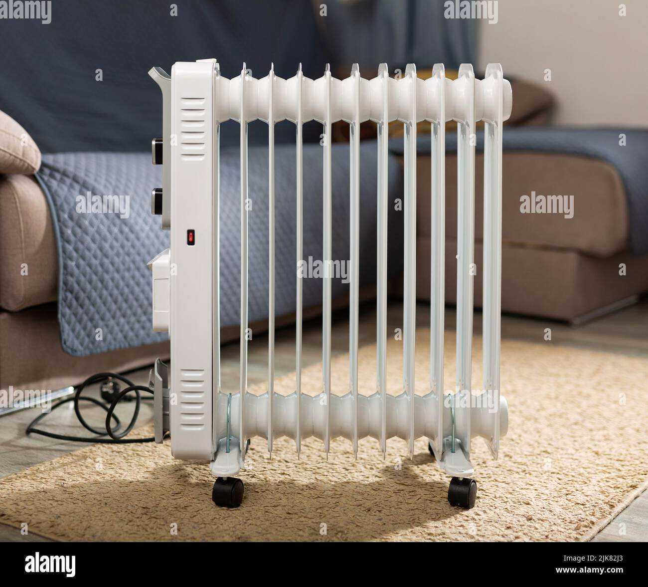 Electric oil heater on floor in room Stock Photo Alamy