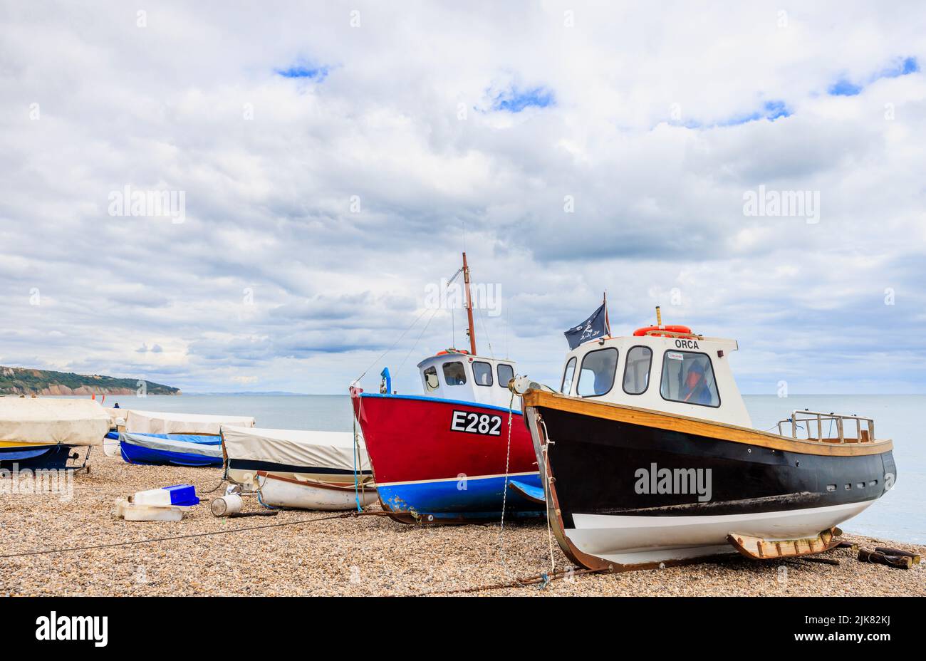 Fishing boats on the shingle beach at Beer, a picturesque small coastal village on Lyme Bay in the Jurassic Coast of East Devon, south-west England Stock Photo