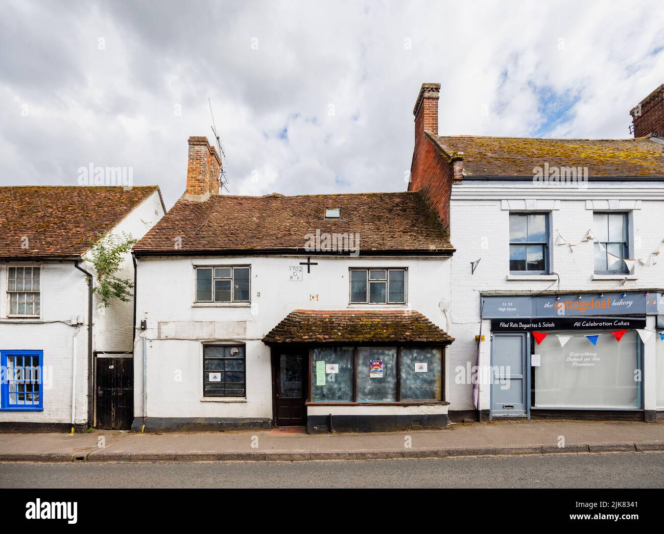 A run-down closed, empty shop in an historic building dated 1702 in High Street, Fordingbridge, a small village in the New Forest, Hampshire Stock Photo
