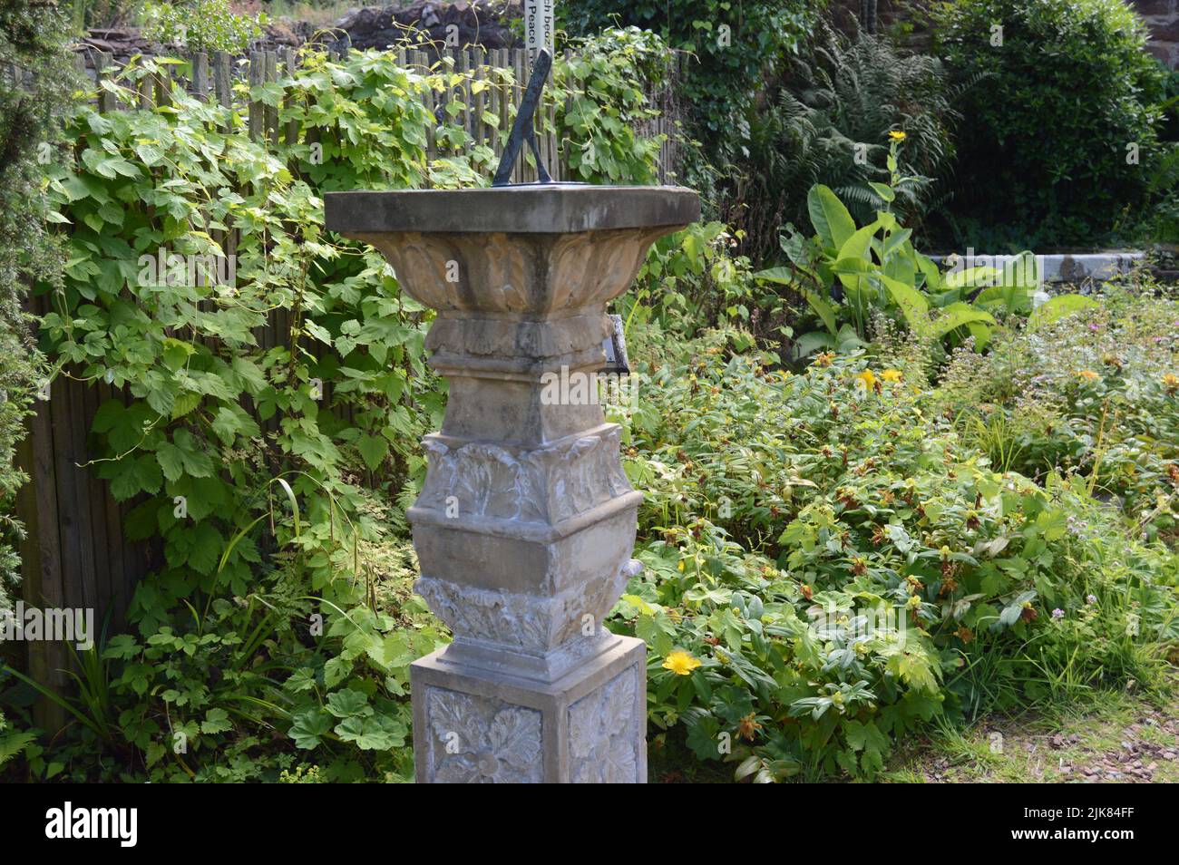 An ornate sundial pedestal carved by Hugh Millar in 18th century, in the garden of his cottage in Cromarty, Scotland Stock Photo