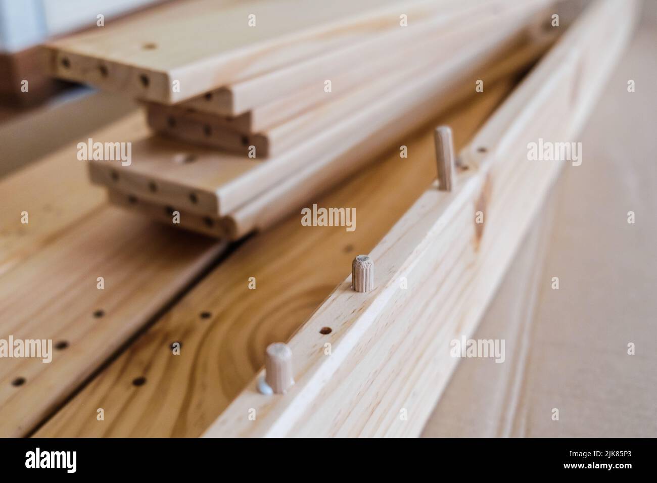 Wooden boards with wooden nails to join a piece of furniture with a ...