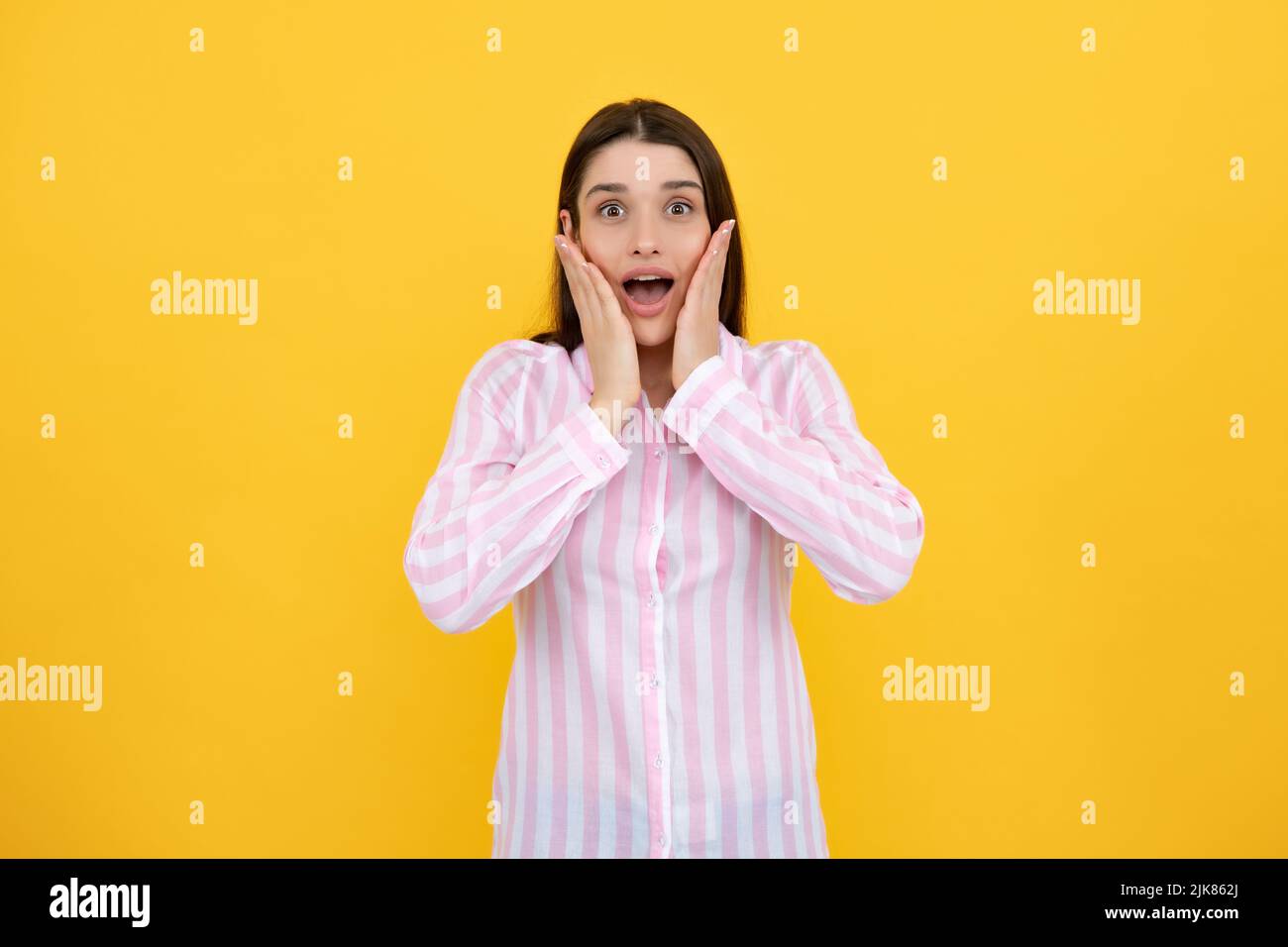 Surprised astonished young woman with open mouth. Portrait of excited amazed gasping girl. Expressive facial expressions. Excited female face. Stock Photo