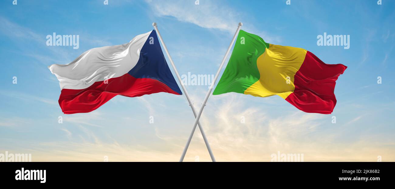 two crossed flags Mali and Czech republic waving in wind at cloudy sky ...