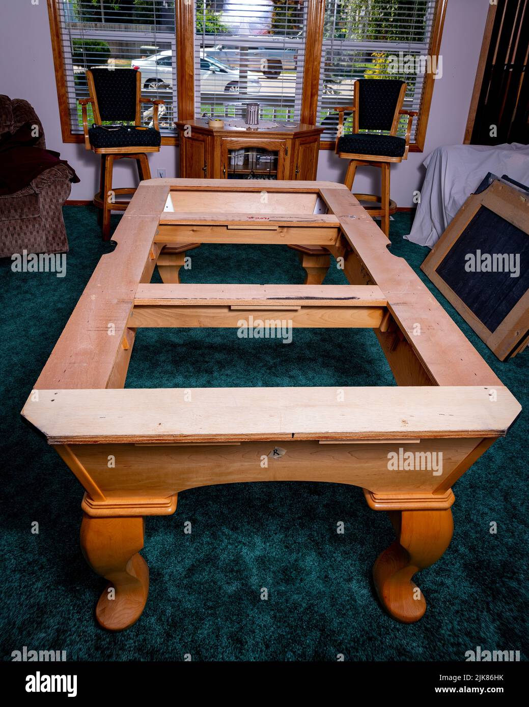 Indoor stripped pool table with maple wood frame Stock Photo
