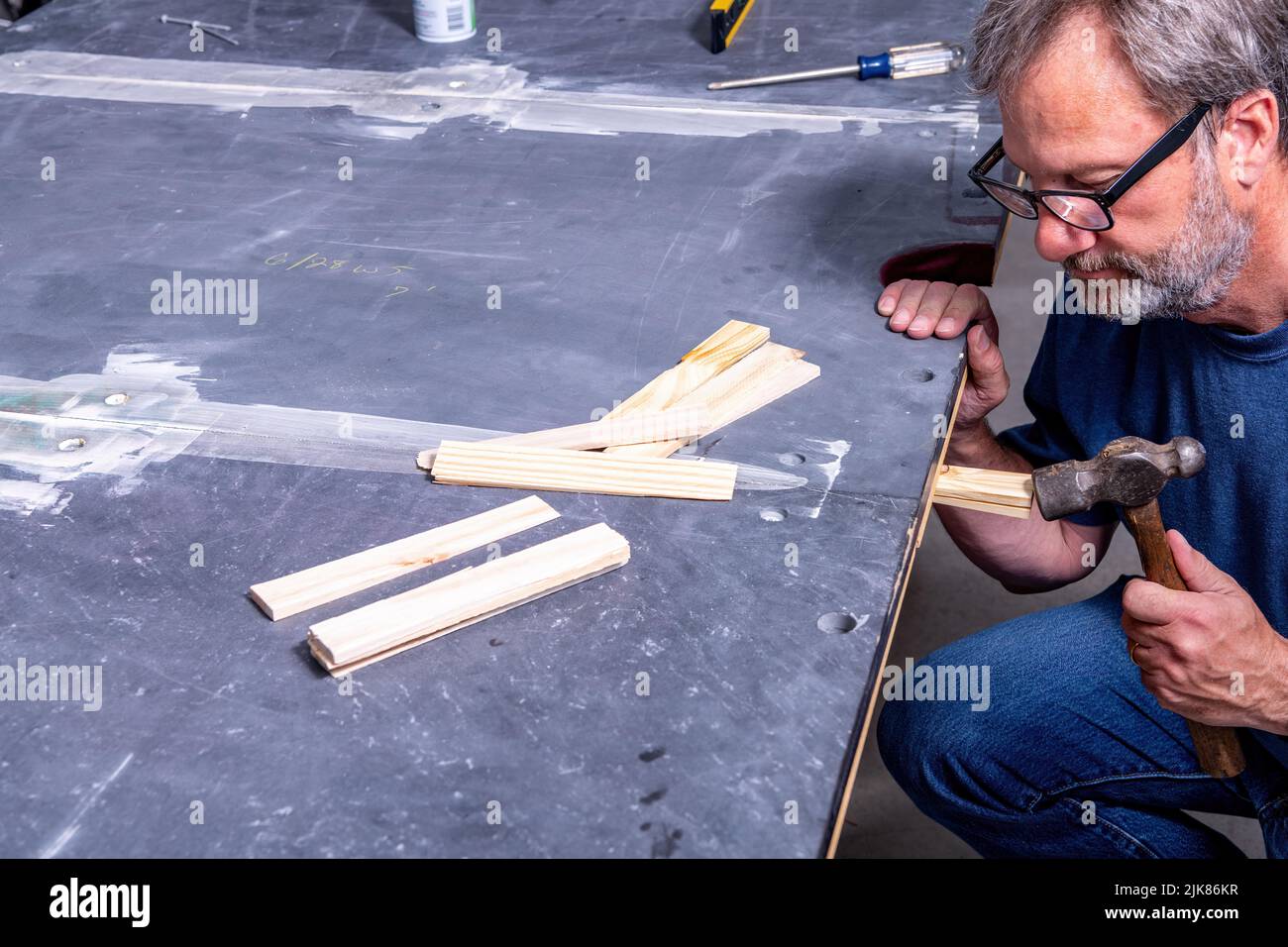 Professional work on a pool table installation Stock Photo