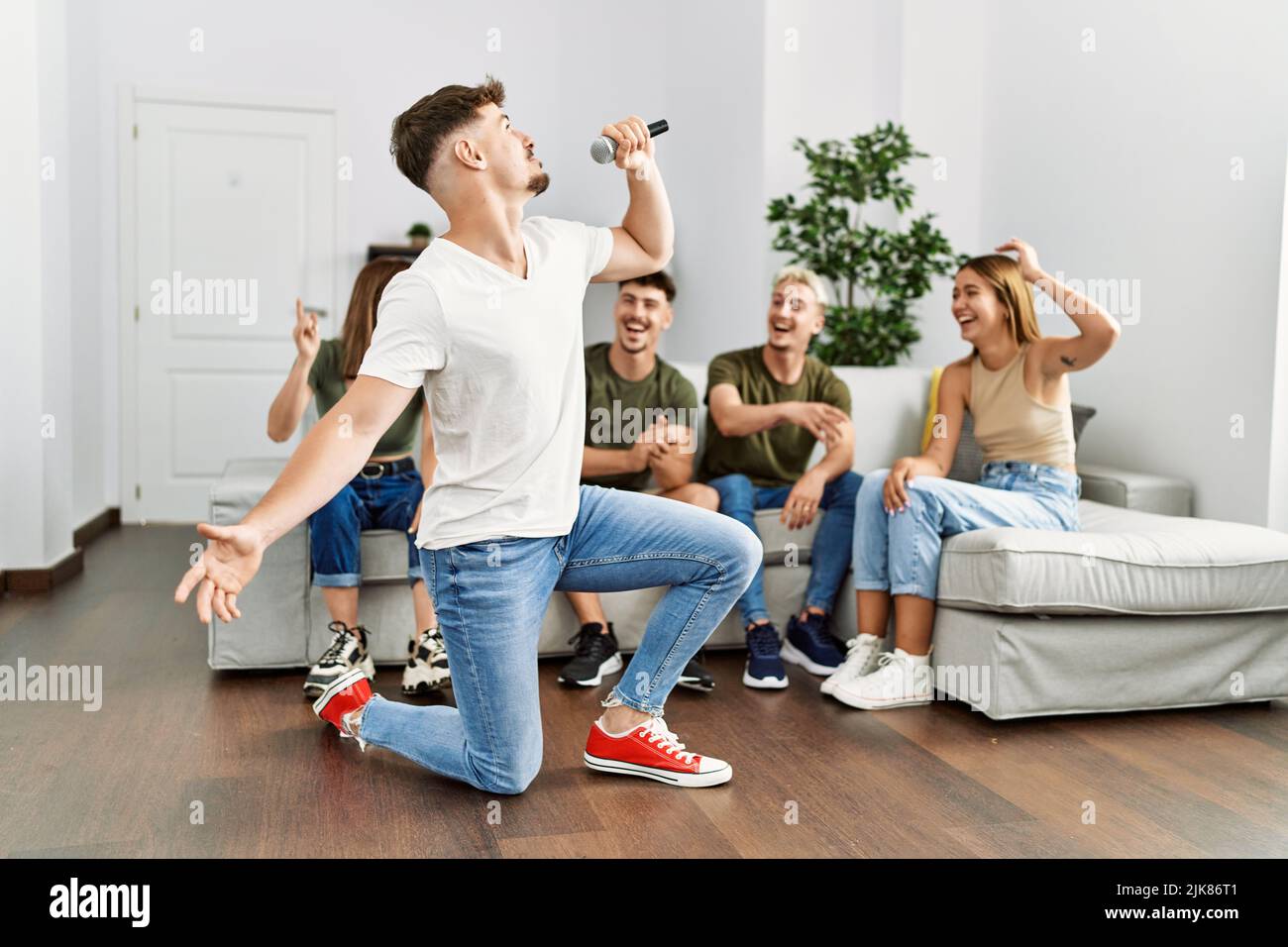 Group of young friends having party singing song using microphone at home Stock Photo Alamy