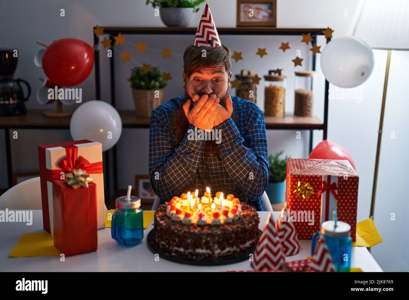 Young man with beard wearing glasses holding birthday cake over isolated  yellow background stressed with hand on head, shocked with shame and  surprise Stock Photo - Alamy