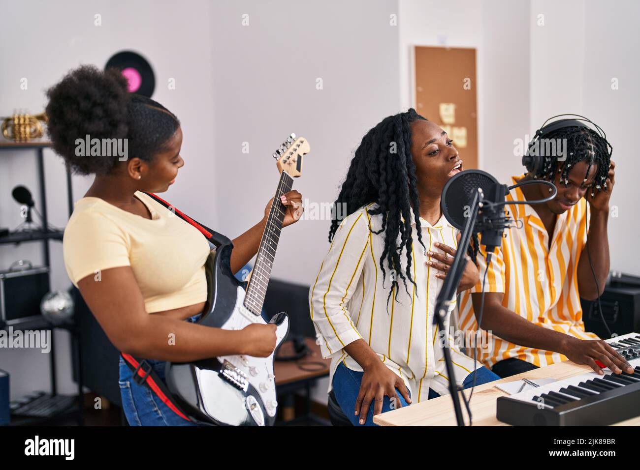 African american friends musicians group singing song at music studio
