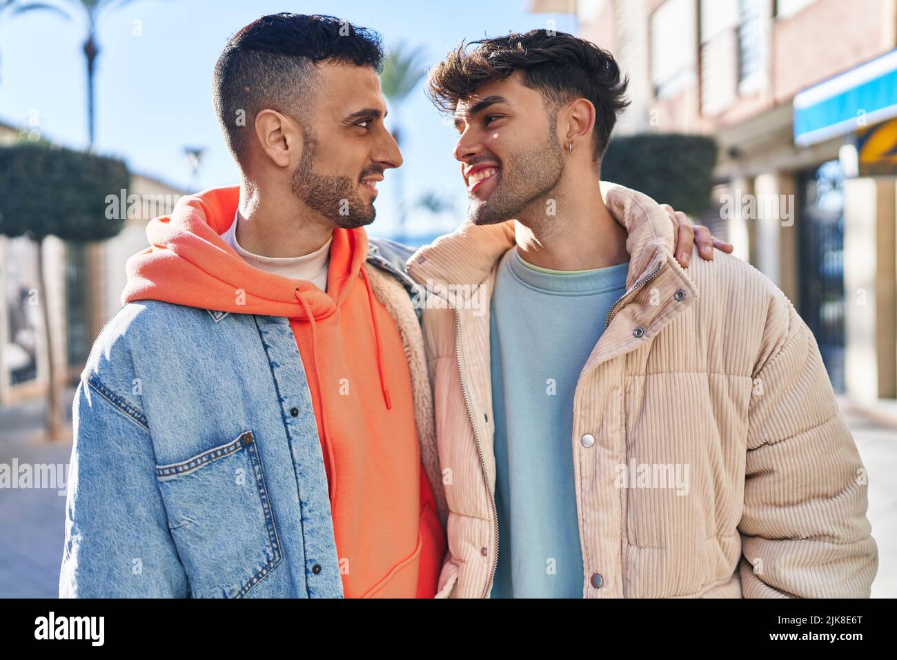 Two man couple hugging each other standing at street Stock Photo - Alamy