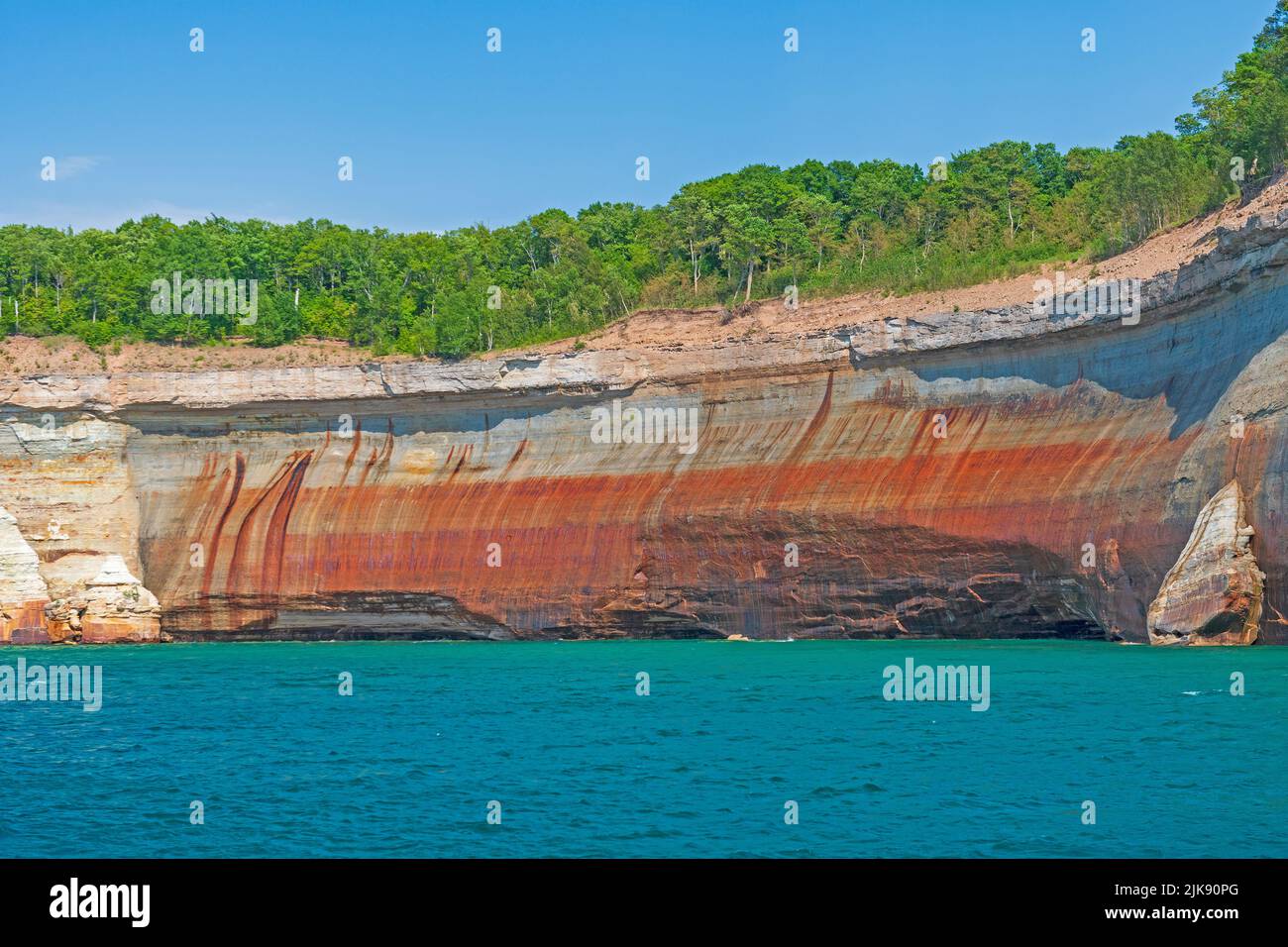 Red Cliffs Above Blue Waters on the Pictured Rocks National Lakeshore in Michigan Stock Photo