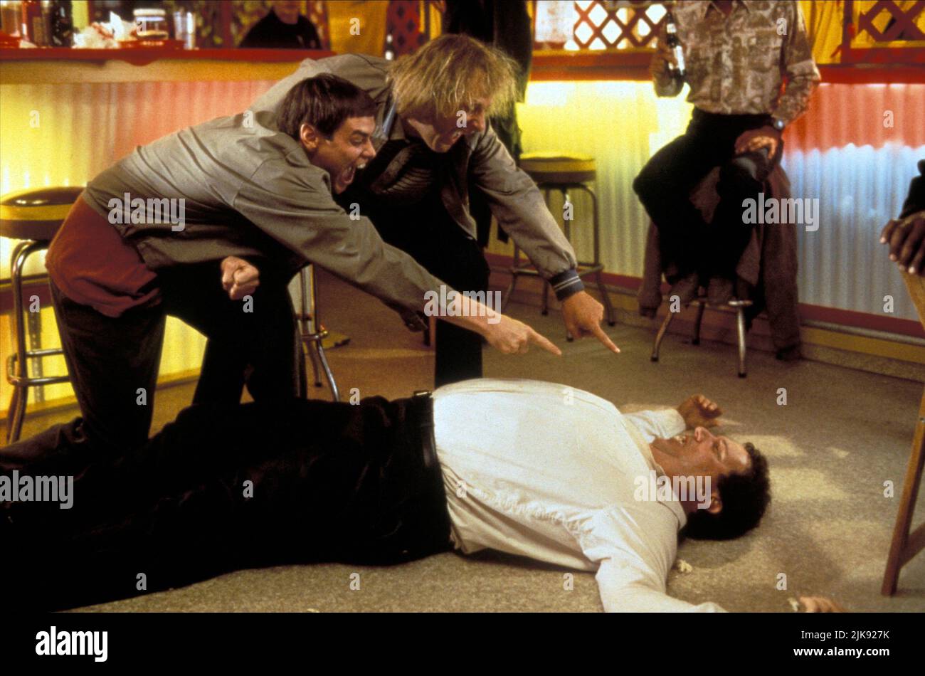 Jim Carrey, Jeff Daniels & Mike Starr Film: Dumb & Dumber; Dumb And Dumber (USA 1994) Characters: Lloyd, Harry, Joe Mentalino  Director: Peter Farrelly 06 December 1994   **WARNING** This Photograph is for editorial use only and is the copyright of NEW LINE CINEMA and/or the Photographer assigned by the Film or Production Company and can only be reproduced by publications in conjunction with the promotion of the above Film. A Mandatory Credit To NEW LINE CINEMA is required. The Photographer should also be credited when known. No commercial use can be granted without written authority from the Stock Photo