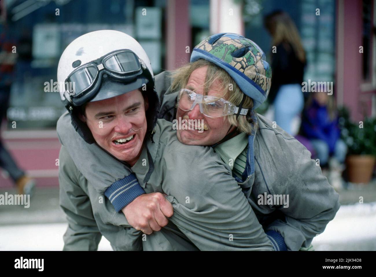 Jim Carrey & Jeff Daniels Film: Dumb & Dumber; Dumb And Dumber (USA 1994) Characters: Lloyd & Harry  Director: Peter Farrelly 06 December 1994   **WARNING** This Photograph is for editorial use only and is the copyright of NEW LINE CINEMA and/or the Photographer assigned by the Film or Production Company and can only be reproduced by publications in conjunction with the promotion of the above Film. A Mandatory Credit To NEW LINE CINEMA is required. The Photographer should also be credited when known. No commercial use can be granted without written authority from the Film Company. Stock Photo