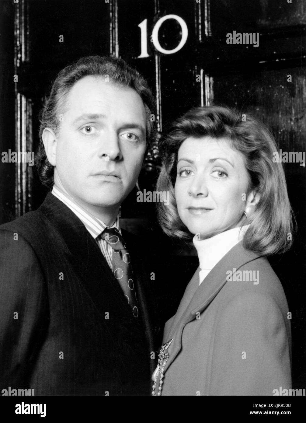 Rik Mayall & Marsha Fitzalan Television: The New Statesman (1991) Characters: Alan B'Stard & Sarah B'Stard  Director: Laurence Marks, Maurice Gran 13 January 1991   **WARNING** This Photograph is for editorial use only and is the copyright of YORKSHIRE TELEVISION and/or the Photographer assigned by the Film or Production Company and can only be reproduced by publications in conjunction with the promotion of the above Film. A Mandatory Credit To YORKSHIRE TELEVISION is required. The Photographer should also be credited when known. No commercial use can be granted without written authority from Stock Photo