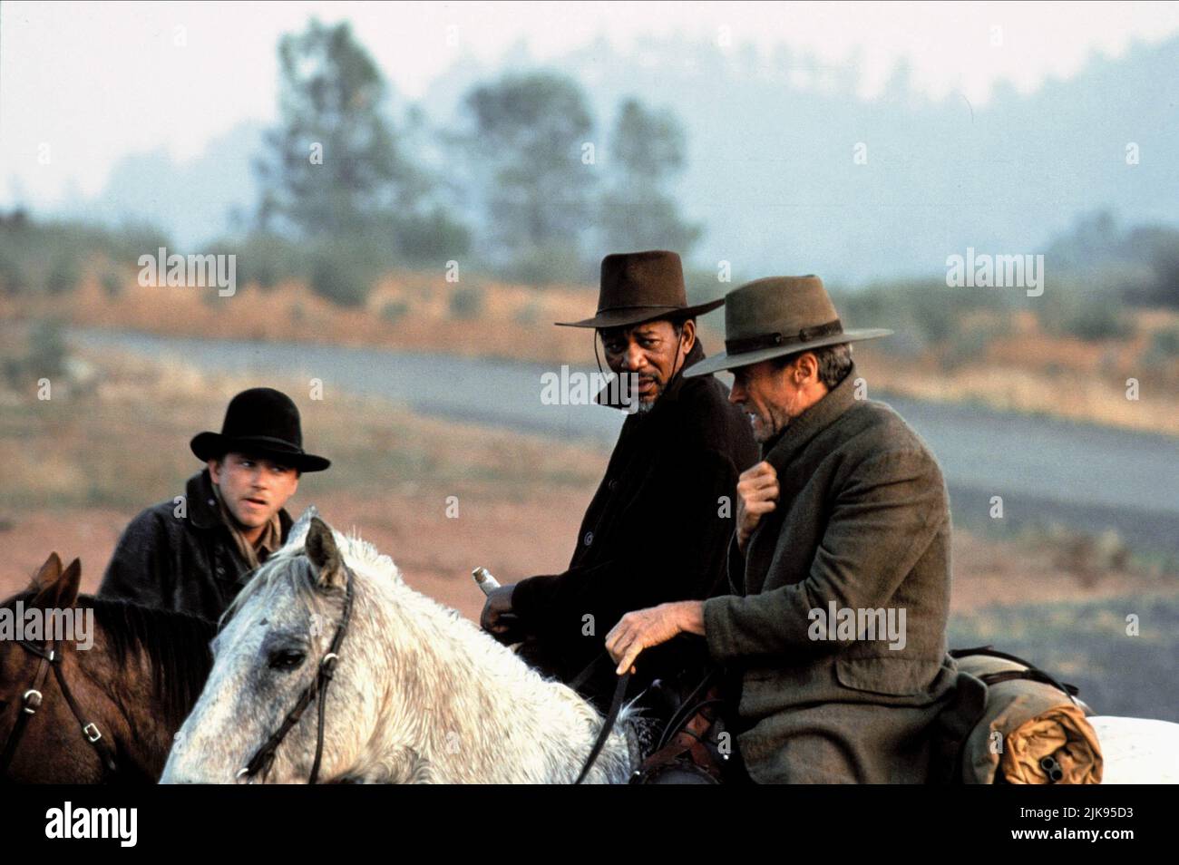 Jaimz Woolvett, Morgan Freeman & Clint Eastwood Film: Unforgiven (USA 1992) Characters: The Schofield Kid,Ned Logan & William 'Bill' Munny  Director: Clint Eastwood 03 August 1992   **WARNING** This Photograph is for editorial use only and is the copyright of WARNER BROS. and/or the Photographer assigned by the Film or Production Company and can only be reproduced by publications in conjunction with the promotion of the above Film. A Mandatory Credit To WARNER BROS. is required. The Photographer should also be credited when known. No commercial use can be granted without written authority from Stock Photo