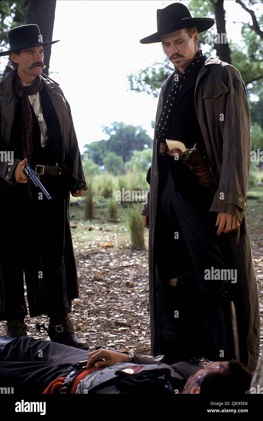 Kurt Russell & Val Kilmer  Film Tombstone (USA 1983) Characters: Wyatt Earp & Doc Holliday  Director: George P. Cosmatos 25 December 1993   **WARNING** This Photograph is for editorial use only and is the copyright of BUENA VISTA and/or the Photographer assigned by the  Film or Production Company and can only be reproduced by publications in conjunction with the promotion of the above  Film. A Mandatory Credit To BUENA VISTA is required. The Photographer should also be credited when known. No commercial use can be granted without written authority from the  Film Company. Stock Photo