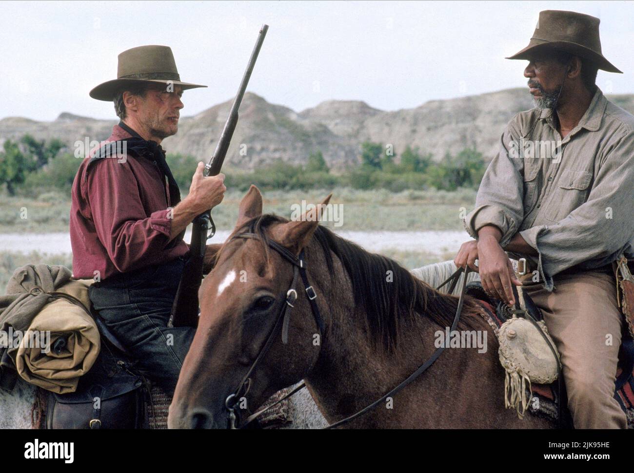 Clint Eastwood & Morgan Freeman Film: Unforgiven (USA 1992) Characters: William 'Bill' Munny & Ned Logan  Director: Clint Eastwood 03 August 1992   **WARNING** This Photograph is for editorial use only and is the copyright of WARNER BROS. and/or the Photographer assigned by the Film or Production Company and can only be reproduced by publications in conjunction with the promotion of the above Film. A Mandatory Credit To WARNER BROS. is required. The Photographer should also be credited when known. No commercial use can be granted without written authority from the Film Company. Stock Photo
