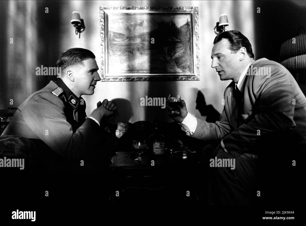 Ralph Fiennes & Liam Neeson Film: Schindler'S List (USA 1993) Characters: Amon Goeth, Oskar Schindler  Director: Steven Spielberg 30 November 1993   **WARNING** This Photograph is for editorial use only and is the copyright of UNIVERSAL and/or the Photographer assigned by the Film or Production Company and can only be reproduced by publications in conjunction with the promotion of the above Film. A Mandatory Credit To UNIVERSAL is required. The Photographer should also be credited when known. No commercial use can be granted without written authority from the Film Company. Stock Photo